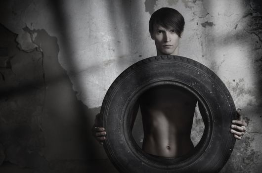 Man holding automobile tire