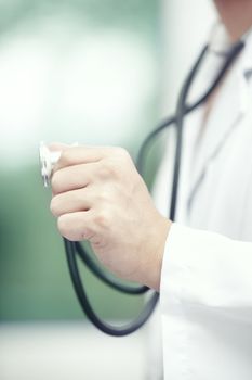 Close-up photo of the doctor hand holding stethoscope