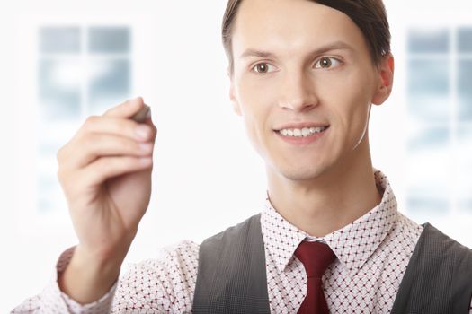 Businessman writing on a virtual board at his office. Empty space can be used for text