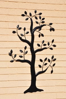 Ornamental tree on a building wall.