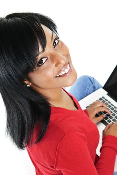 Smiling black woman looking up and typing on computer