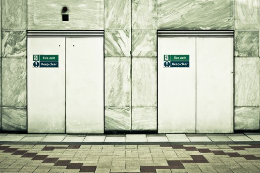 Two fire exit doors in a modern urban building