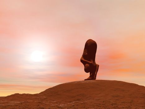 Young woman doing standing forward pose, Uttanasana, while practicing yoga outside in front of sunset