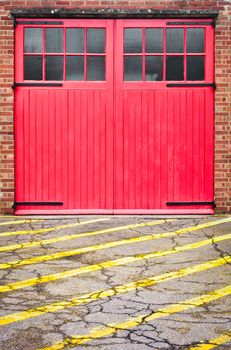Red fire station door with yellow lines