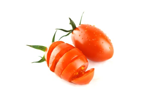 fresh cherry tomatoes with water drops and slices on white background