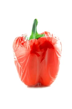 Red sweet pepper wrapped by food wrap on a white background