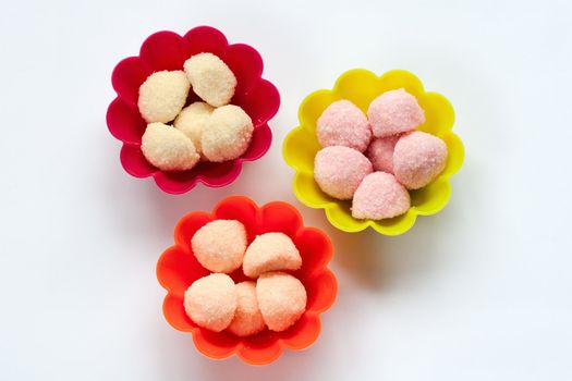 sweet jelly candies in cup cake cases on white