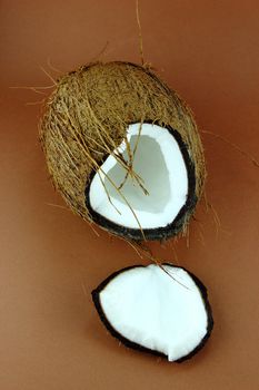 fresh Coconuts with parts on brown background