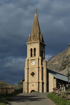 Facade and entrance of church Saint Michel Saint Mammes by sunset, Cervieres, Alps, France