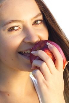 portrait of a beautiful young woman with apple  outdoor