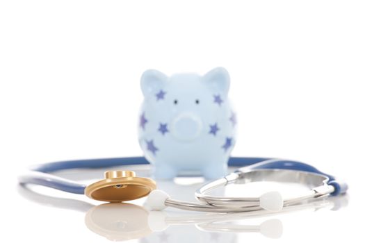 Piggy bank and stethoscope isolated on white