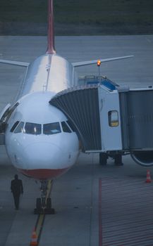 Parked aircraft on  airport through the gate window