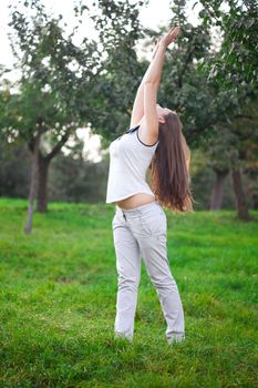 beautiful young woman standing on green grass