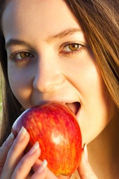 portrait of a beautiful young woman with apple  outdoor