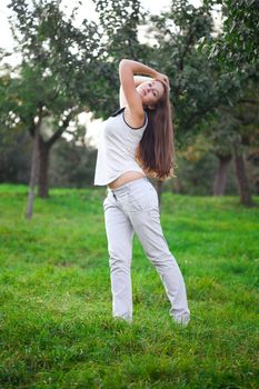 beautiful young woman standing on green grass