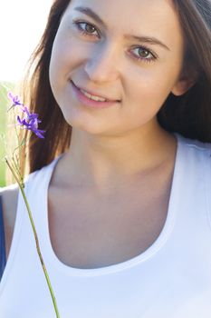 portrait of a beautiful young woman with flower  outdoor