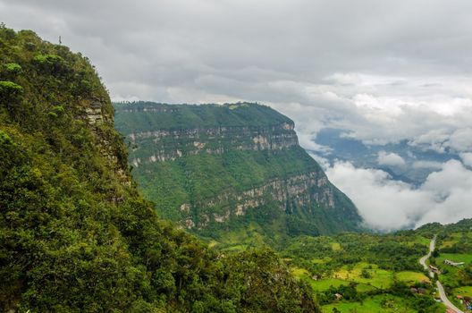 Dramatic view of forest covered cliffs with a valley far below