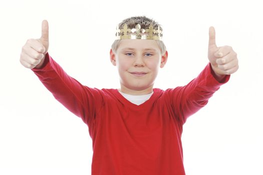 Young boy with crown giving you thumbs up isolated on white background 