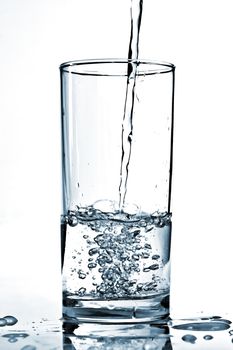 Cold water being poured into a glass.