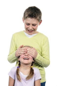 portrait of brother and sister with hand on eyes