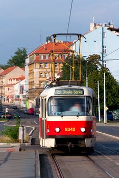The tram moves on rails down the street Prague 