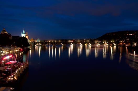 Night look on nabarezhny the Vltava Rivers and Karlov Bridge in Prague  