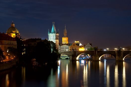 Night look on nabarezhny the Vltava Rivers and Karlov Bridge in Prague  