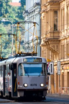 The tram moves on rails down the street Prague 