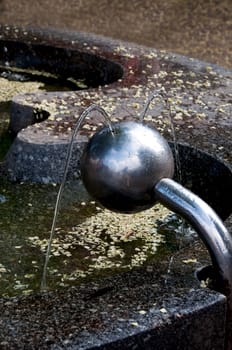 Drinking fountain in the form of a ball beating in two streams  