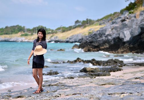 Beautiful young woman on beach summer holiday. Portrait of asian 