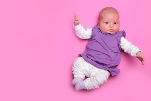 Picture of 1 month newborn on a pink background