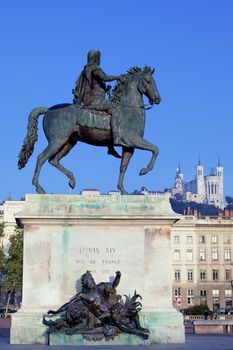 famous statue of Louis and Fourviere basilic on a background