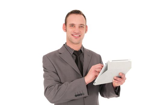 Smiling businessman working on his tablet isolated on white
