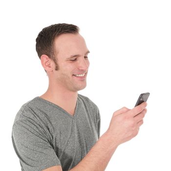 Happy young man reading a text message on his cell phone isolated on white