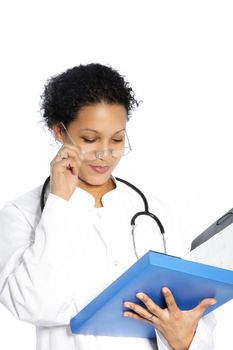 Attractive African American woman doctor reading a patients file lowering her glasses with her hand as she struggles to read isolated on white