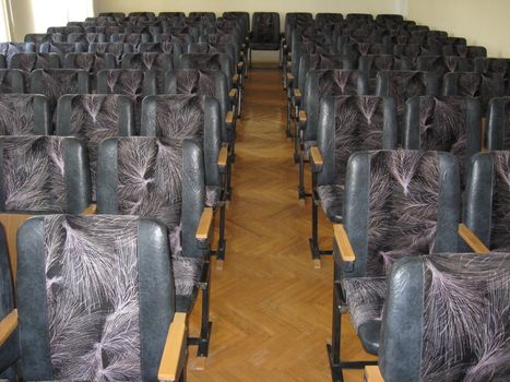 The image of conference room with dark chairs