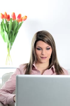 woman on sofa with laptop at home