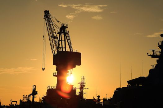 Cranes in dockyard  at sunset