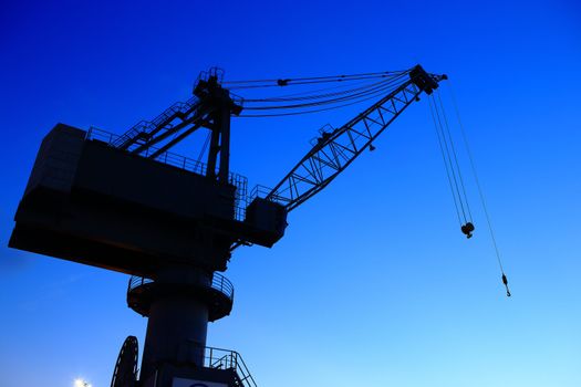 Cranes in dockyard  at sunset