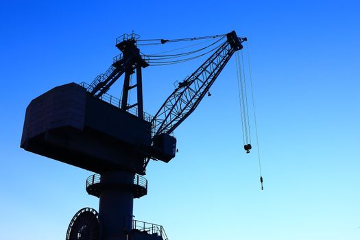 Cranes in dockyard  at sunset
