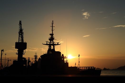 Cranes in dockyard  at sunset