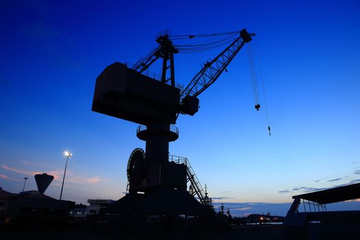 Cranes in dockyard  at sunset