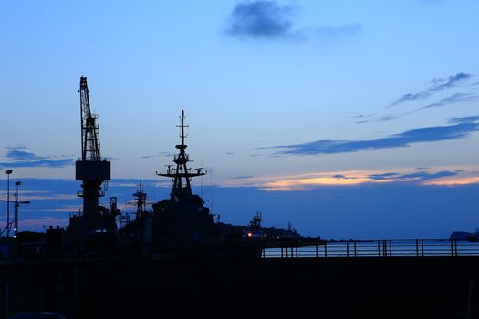 Cranes in dockyard  at sunset