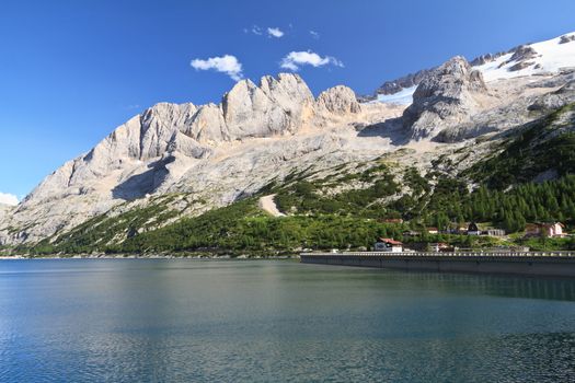 summer view of Fedaia lake beneath Marmolada glacier, Trentino, Italy