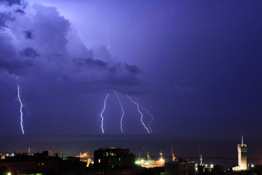Lightning into the sea near the port of Genova, Italy during a violent storm