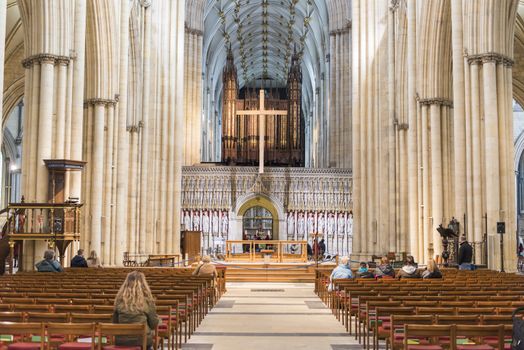 YORK, UK - MARCH 29: Aisle with rows of pews in York Minster central tower. The cathedral dates back from 1291. March 29, 2013 in York.