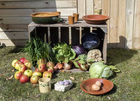 outside still life with food fruit vegetables and wooden case