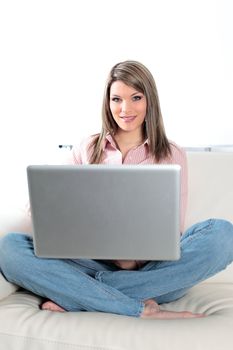 beautiful blond woman on sofa with computer