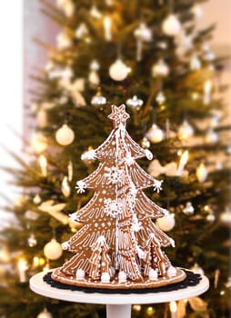 Gingerbread Christmas tree on real fir tree background