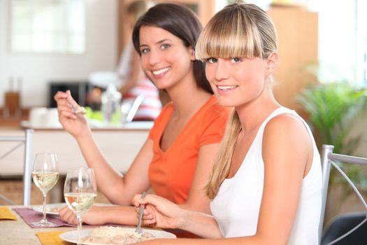 Two girls eating in the kitchen